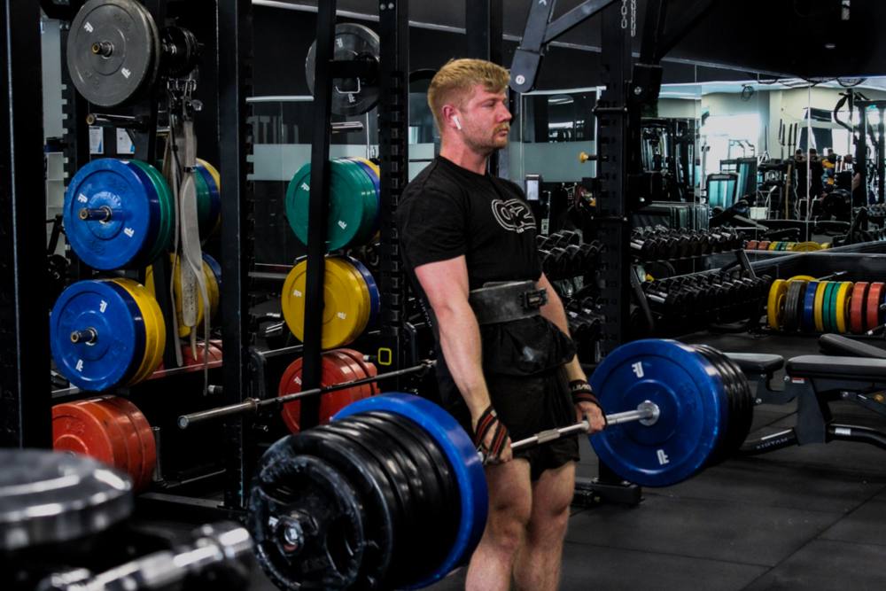 Member deadlifting on the Ultra Fitness strength floor