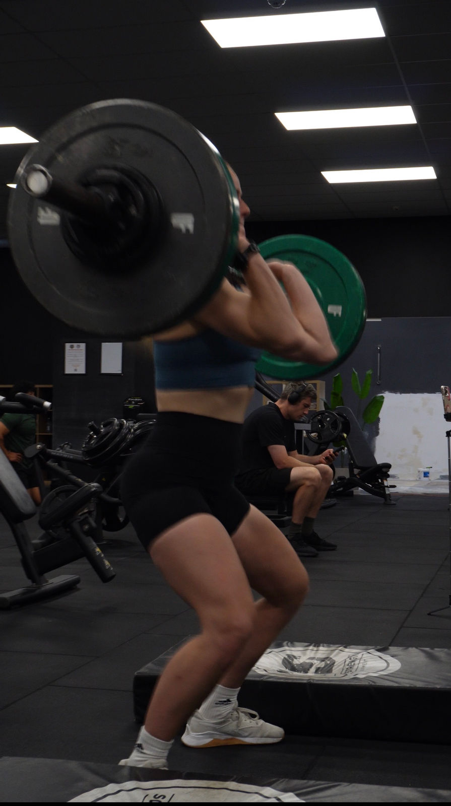 Member back-squatting on the strength floor